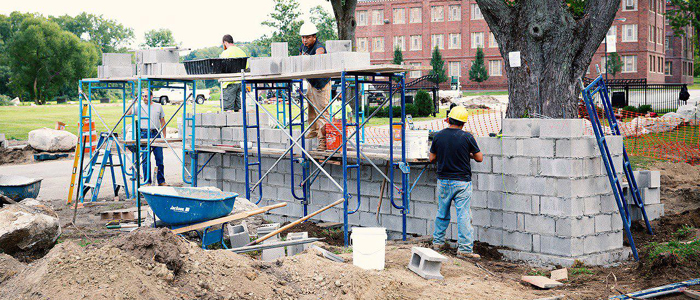 Concrete Blocks Being Built by Masons