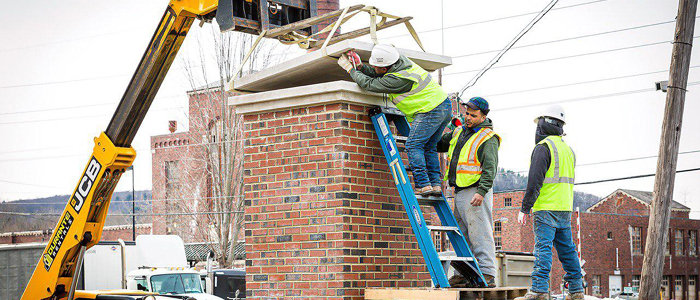 Limestone Caps Installed on Main Entrance Pillars